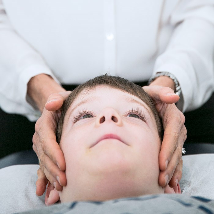 chiropractor adjusting boy